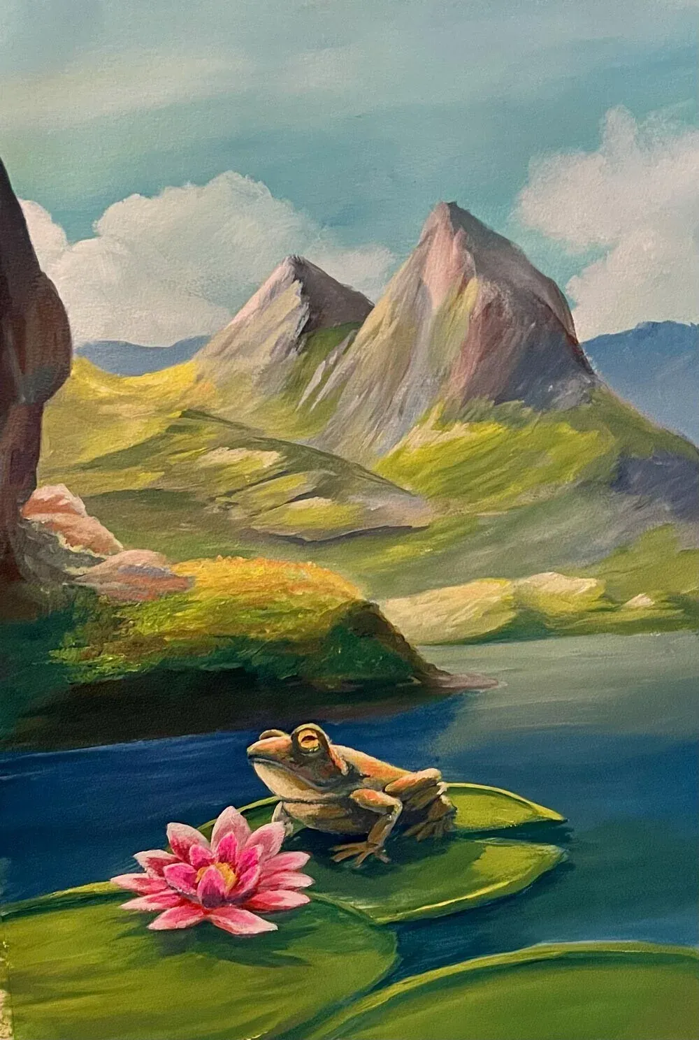 A frog rests on a lily pad next to a pink water lily, on a calm blue lake with soft green hills behind.